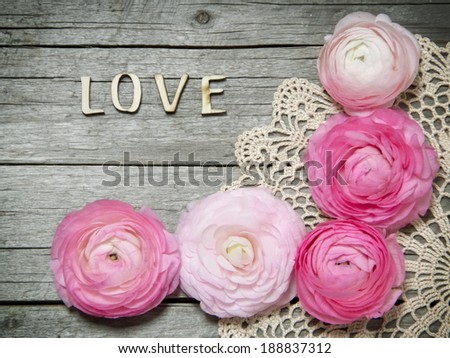 Ranunculus flowers and letters LOVE on wood