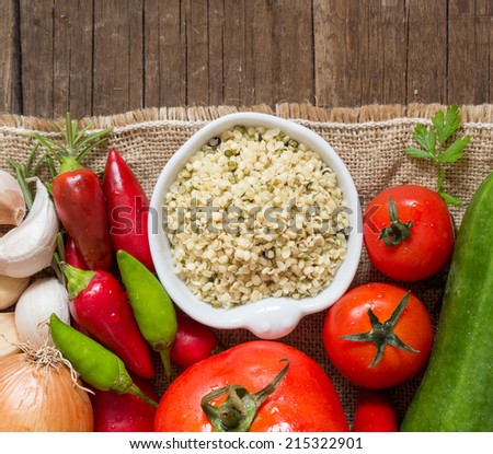 Raw Organic  hemp seeds and vegetables on wooden table