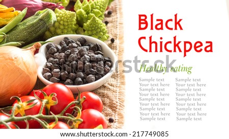 Black chickpea in a bowl with vegetables isolated on white