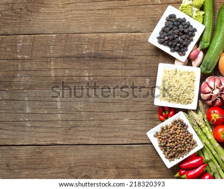Roveja, hemp seeds, black chickpea and vegetables on a wooden table