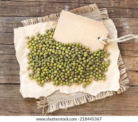 Mung beans and paper label on a wooden table