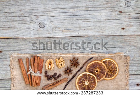 Spices background with dried oranges, all spices, cinnamon, anise, walnuts