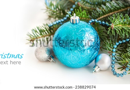 Turquoise and silver Christmas ornaments border on white background