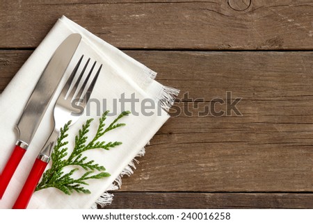Festive table setting with napkin on wooden background