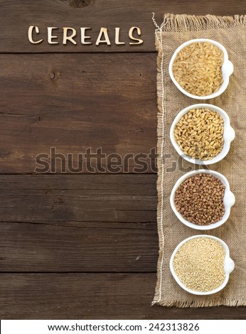 Cereals in bowls border with word Cereals on wood