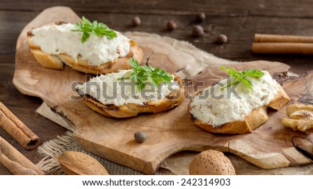 Toasted bread with a salted codfish mousse on wooden cutting board
