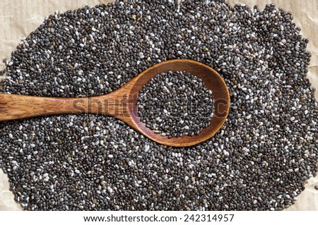 Chia seeds with spoon on a craft paper background
