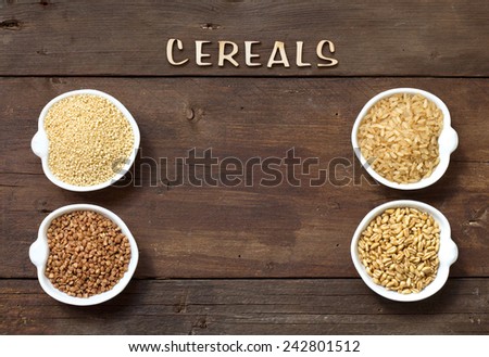 Cereals in bowls border with word Cereals on wood