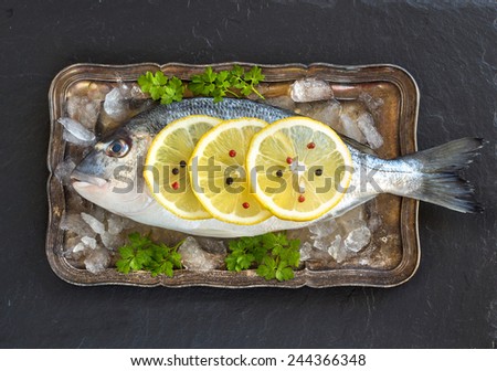 Fresh dorado fish on ice on vintage silver tray