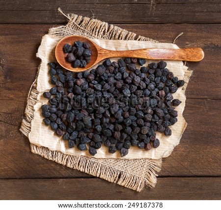 Pile of Black Chickpea with a spoon on a wooden background