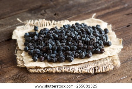 Pile of black chickpea on a old wooden background