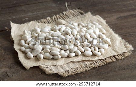 Pile of White beans on a wooden background