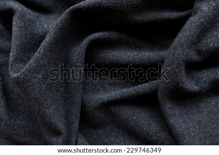 Black creased fabric background or texture