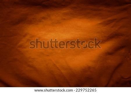 Orange fabric background and vignette