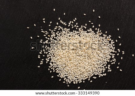Sesame seeds on black stone background