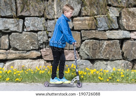 Boy riding a scooter