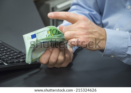 Close-up of bank clerk counting 100-euro bills