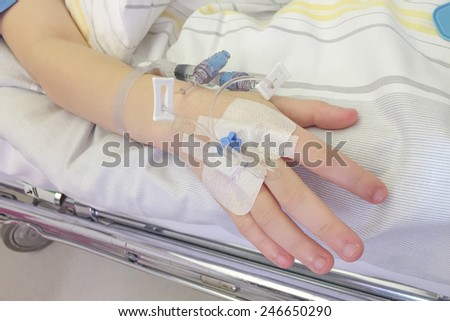 Young boy getting glucose injection in vain