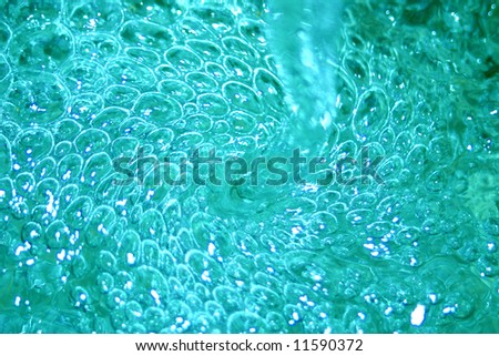 Swirl of water and bubbles with bursting turquoise and cyan colors