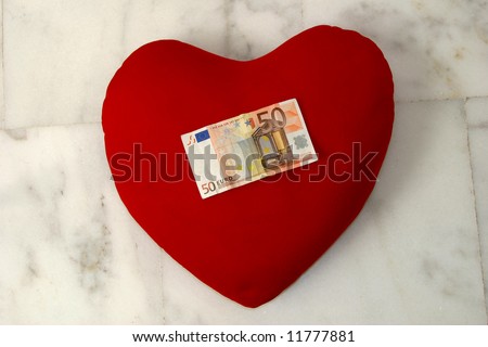 A fifty Euro bill on a heart. Concepts - love and money