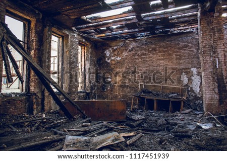 Burned house interior after fire, ruined building room inside, disaster or war aftermath concept