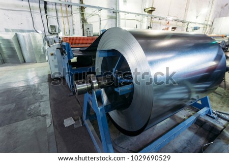 Roll of galvanized steel sheet feeds steel sheets to the cutting machine for manufacturing metal pipes and tubes in the factory
