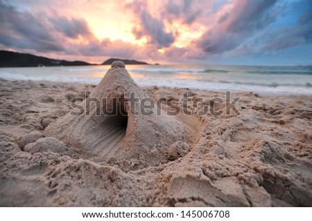 Sand castle by the sea sunset.