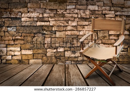Director\'s chair on the wood and brick background