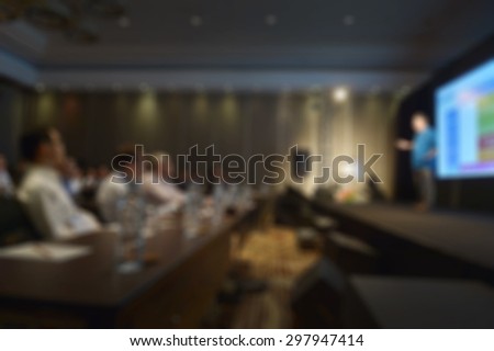 blurred man with projection screen conference room