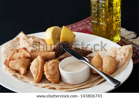 Warm meszzeh traditional Middle eastern food  a platter of kibbeh,spinach fatayer,cheese sambousek,cheese rakakat