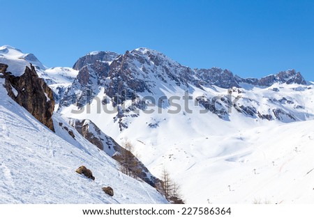 View from the slope with rocks and mountains on the lift.