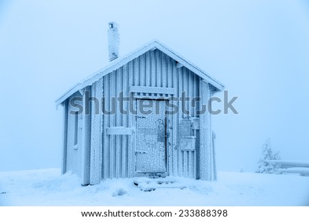 Hut covered with frost, standing on top of a mountain. Finnish Lapland.