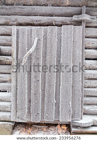 Barn door covered with frost. Finnish Lapland.