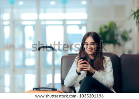 Woman Reading Phone Messages in Airport Waiting Room. Happy girl buying e-ticket, making hotel reservations and checking in online