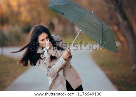 Girl Fighting The Wind Holding Umbrella Raining Weather. Autumn woman having problems in windy storm