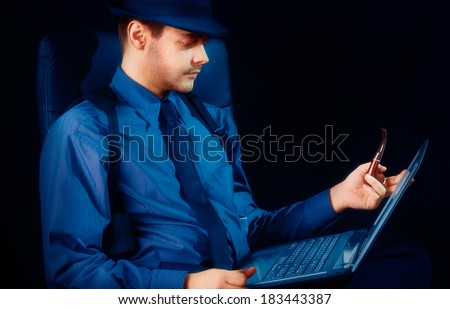 Man with Hat and Pipe Looking at Laptop - Man with hat and pipe looking at a laptop