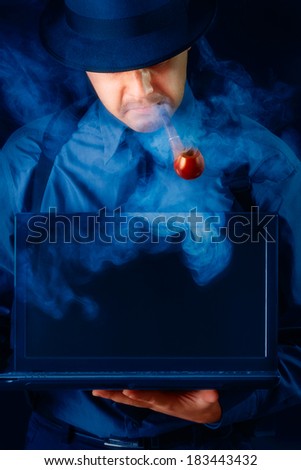 Man with Hat and Pipe Holding Laptop with Black Screen - Man wearing hat and smoking pipe is holding a laptop showing the blank screen
