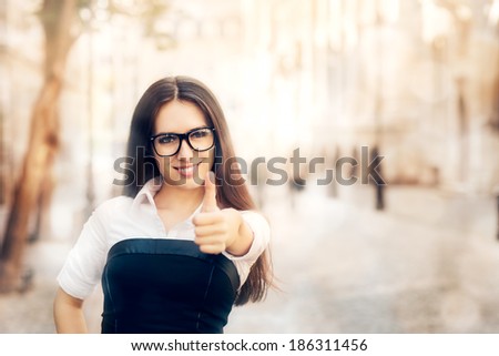 Young Woman with Glasses Thumb Up - Young woman with glasses making a thumb up gesture