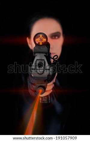 Woman Spy Aiming Gun with Laser Sights - Woman in a black leather suit pointing a gun with laser sights at the camera