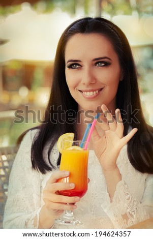 Young Woman with Colorful Cocktail Drink Outside - Beautiful woman enjoying a cocktail drink on a sunny day