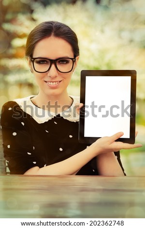 Young Woman with Glasses Showing an Empty Tablet Screen - Beautiful woman holds a tablet up, showing the empty white screen