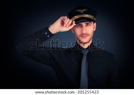 Pilot Salute Low Key Portrait - Young pilot wearing black shirt and tie salute portrait on black background