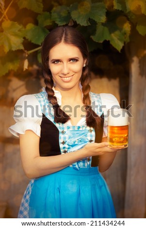Young Bavarian Woman Holding Beer Tankard - Young woman in German dress holding a glass beer mug