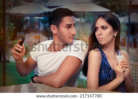 Secretive Couple with Smart Phones in Their Hands - Young adult couple has privacy problems with modern technology