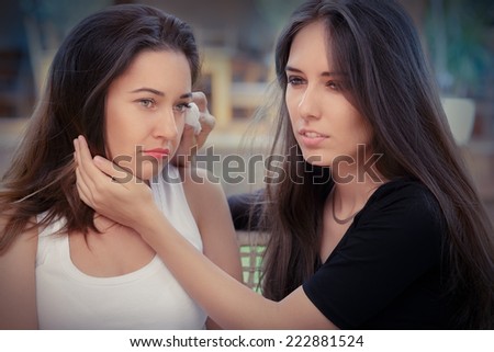 Young woman comforting tearful friend - Portrait of Two women console each other in painful situation