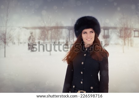 Young Woman in The Snow in Wintertime - Beautiful stylish woman outside in the cold