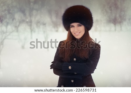 Young Woman in The Snow in Wintertime - Beautiful stylish woman outside in the cold