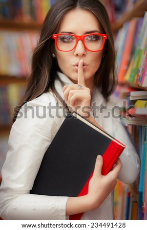 Young Woman Asking for Silence in the Library Room - Portrait of a woman doing a quiet request gesture