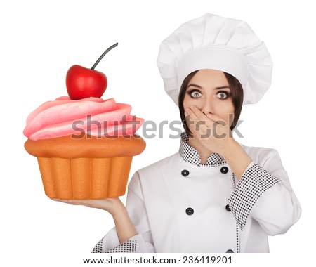 Amazed Woman Pastry Chef Holding Huge Cupcake - Portrait of a professional cook surprised by the giant baked and decorated muffin