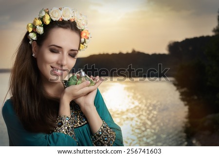 Young Woman Holding Perfume Bottle at Sunset - Portrait of a glamorous woman with retro fragrance recipient in seaside landscape